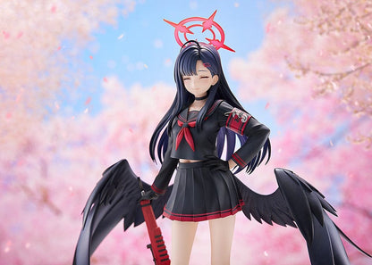 Blue Archive Ichika 1/7 scale figure in a dark school uniform with black wings, holding a red weapon and wearing a symbolic red halo-like accessory, with a calm, closed-eyed expression.