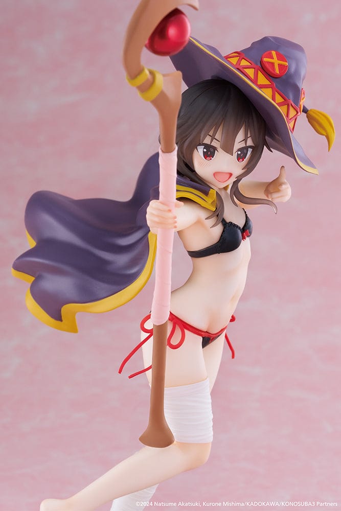 KonoSuba's Megumin Coreful Figure presented in a Swimwear Version, energetically wielding her staff, adorned with her signature hat and a playful swimsuit. The figure captures her mischievous smile and readiness for summer fun, reflecting her explosive character from the beloved anime series.