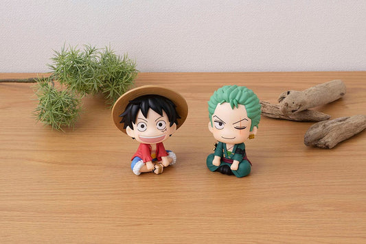 One Piece Look Up series figures of Monkey D. Luffy with his straw hat and Roronoa Zoro in his green bandana, both characters sitting and looking upwards with characteristic expressions, evoking their adventurous and loyal partnership from the series.
