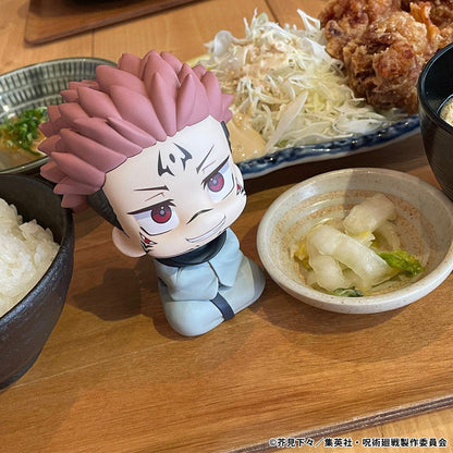 Lookup Figure Jujutsu Kaisen Sukuna in seated chibi form with signature face markings and red eyes, smiling mischievously.