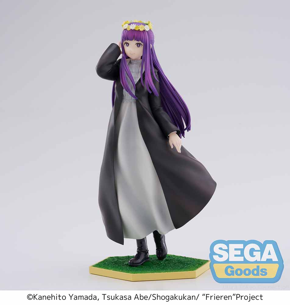 Frieren: Beyond Journey's End Luminasta Fern (Flower Garden) Figure featuring Fern in a long black coat, gray dress, and daisy crown on a grass-textured hexagonal base, set against a white background.