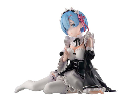 Detailed figure of Rem from Re:Zero, dressed as a maid in black and white, with blue hair and a floral headband, lying down with a gentle expression, encapsulating her Melty Princess persona in Tenohira size.