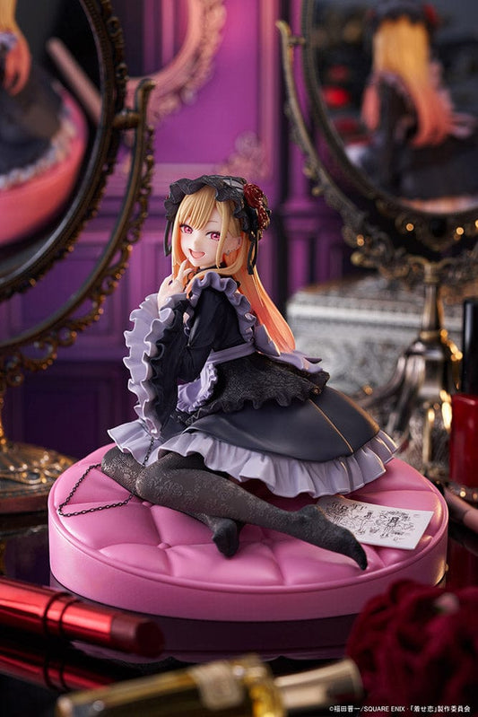 My Dress-Up Darling AMP+ Marin Kitagawa (Dress of Shizuku Kuroe Ver.) Figure, displayed in a gothic lolita dress, sitting playfully on a pink cushion base, perfect for fans and collectors of unique character figures.