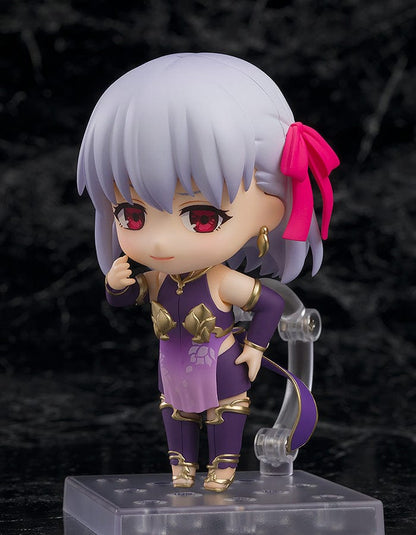 Fate/Grand Order Nendoroid No.2513 featuring Assassin/Kama in a purple and gold outfit with red eyes and a pink hair accessory.