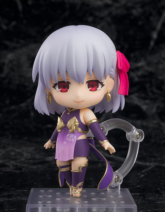 Fate/Grand Order Nendoroid No.2513 featuring Assassin/Kama in a purple and gold outfit with red eyes and a pink hair accessory.