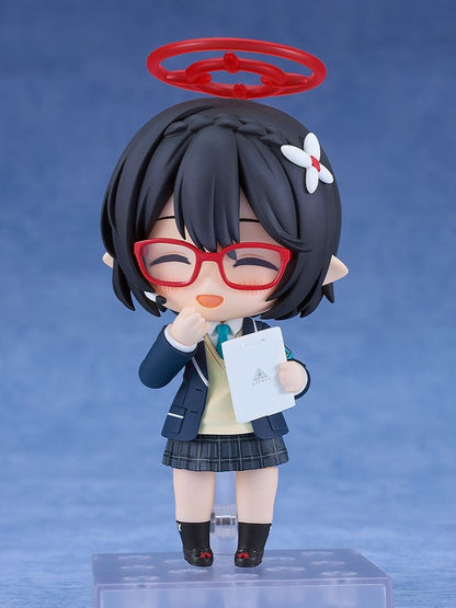 Blue Archive Nendoroid No.2657 Ayane Okusora in a school uniform, with red glasses, dark braided hair with a flower clip, and a red halo accessory, holding a book.