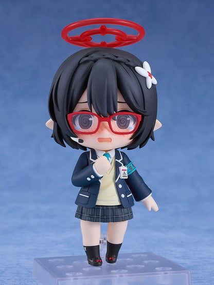 Blue Archive Nendoroid No.2657 Ayane Okusora in a school uniform, with red glasses, dark braided hair with a flower clip, and a red halo accessory, holding a book.