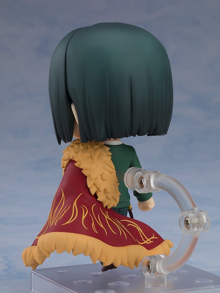 Fate/Grand Order Nendoroid No.2667 Caster/Zhuge Liang figure in a pose holding a spellbook, wearing a green suit and crimson cape with gold detailing.