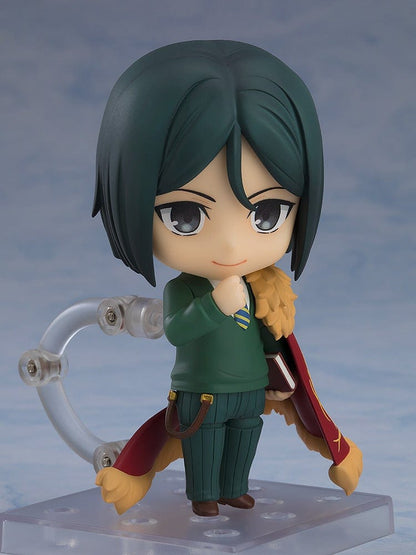 Fate/Grand Order Nendoroid No.2667 Caster/Zhuge Liang figure in a pose holding a spellbook, wearing a green suit and crimson cape with gold detailing.