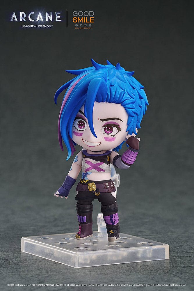 Nendoroid Jinx (Arcane Ver.) from League of Legends: Arcane, showcasing her iconic blue hair, purple outfit, and detailed weapon, posed with a confident grin.