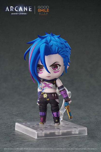 Nendoroid Jinx (Arcane Ver.) from League of Legends: Arcane, showcasing her iconic blue hair, purple outfit, and detailed weapon, posed with a confident grin.