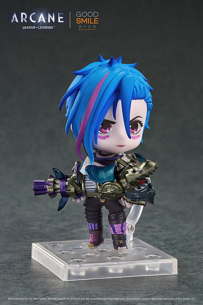 Nendoroid Jinx (Arcane Ver.) from League of Legends: Arcane, showcasing her iconic blue hair, purple outfit, and detailed weapon, posed with a confident grin.