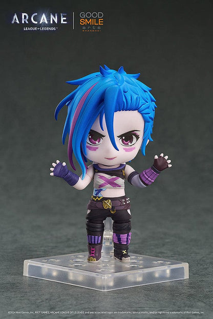 Nendoroid Jinx (Arcane Ver.) from League of Legends: Arcane, showcasing her iconic blue hair, purple outfit, and detailed weapon, posed with a confident grin.