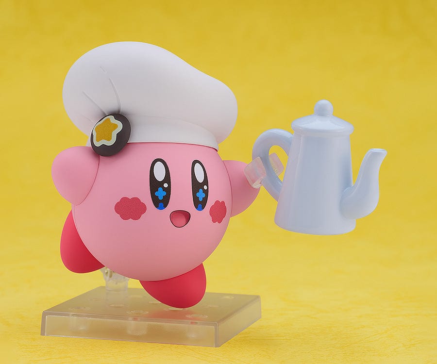 Kirby Nendoroid No.2598 (Cafe Ver.) dressed as a chef, holding a fork, with a green Kirby Café signboard.