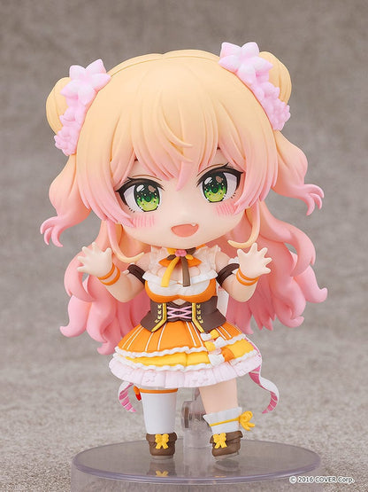 Hololive Production Nendoroid No.2502 Momosuzu Nene figure featuring Nene in her colorful idol outfit, smiling with her hands raised in excitement.