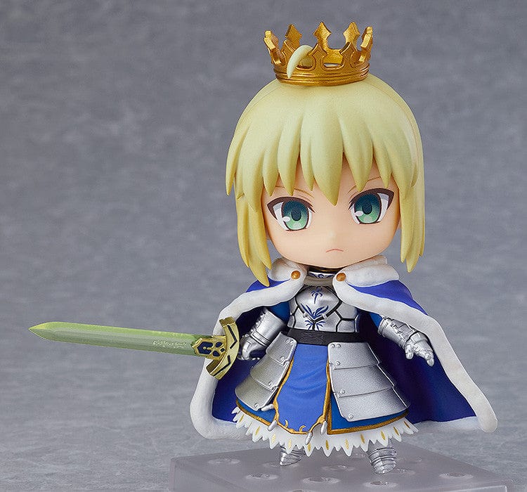 Chibi-style Nendoroid figure of Altria Pendragon (Saber) from Fate/Grand Order, wearing a crown, armored outfit, blue cape, and holding Excalibur sword – True Name Revealed Ver. (Reissue).

