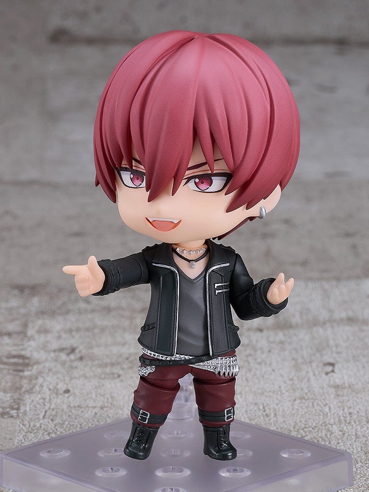 IDOLiSH7 Nendoroid Toma Inumaru figure featuring a black jacket, burgundy pants, and confident pose with interchangeable faceplates, set against a textured gray background.