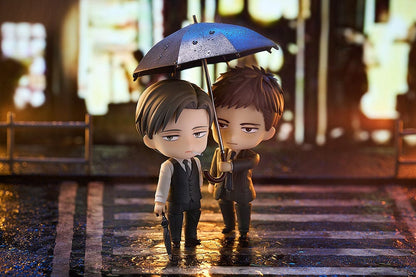 Twittering Birds Never Fly Nendoroid set featuring Yashiro and Chikara Domeki figures. Domeki holds an umbrella over Yashiro, both dressed in formal attire with a city background.