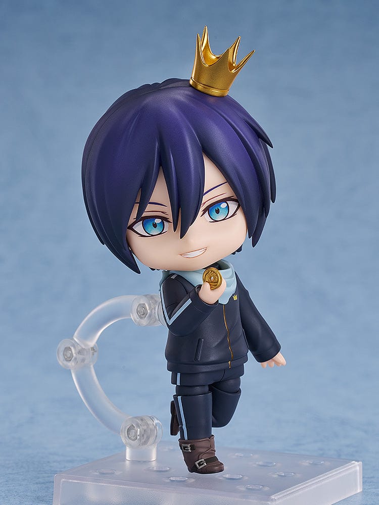 Noragami Nendoroid No.2565 Yato in his iconic dark tracksuit with blue scarf, smiling confidently.