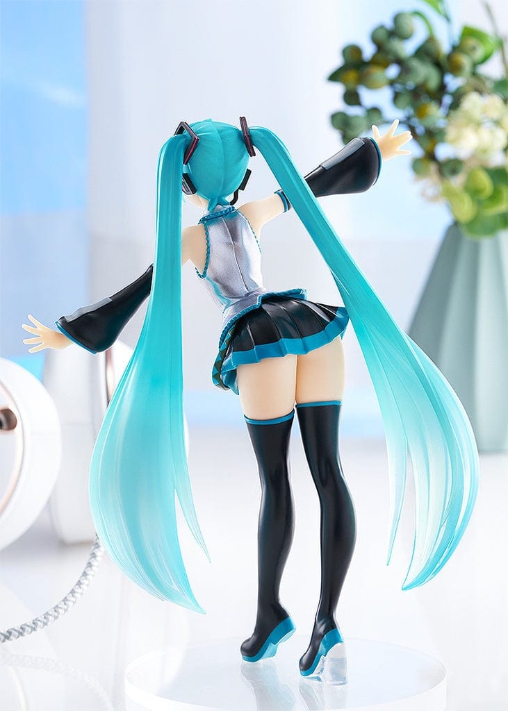 Vocaloid Pop Up Parade Miku Hatsune in a translucent color version, with her iconic turquoise twintails and a cheerful expression. She is dressed in her signature outfit, modified with translucent elements that give her a luminous and ethereal appearance.