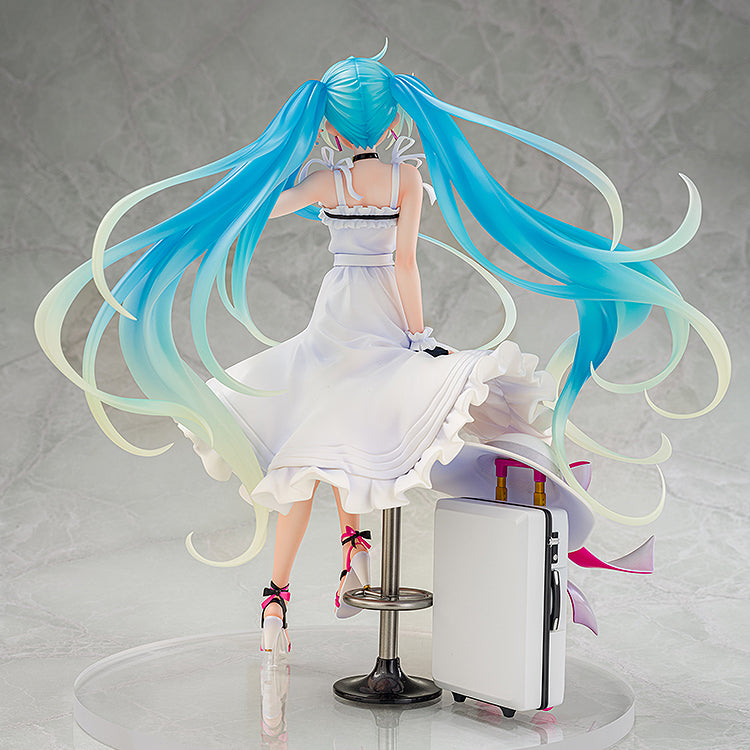 Vocaloid Hatsune Miku GT Project Racing Miku (2021 Vacation Style Ver.) 1/7 Scale Figure featuring Miku in a flowing white dress with dynamic twin-tails, sitting on a stool with a suitcase beside her, capturing a moment of relaxed elegance.