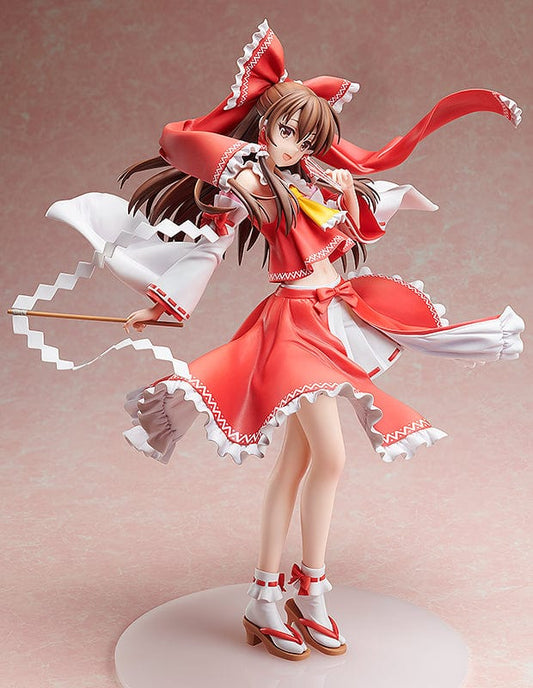 A large 1/4 scale figure of Reimu Hakurei from the Touhou Project, featuring her in traditional red and white shrine maiden attire, dynamically posed as if in mid-movement.