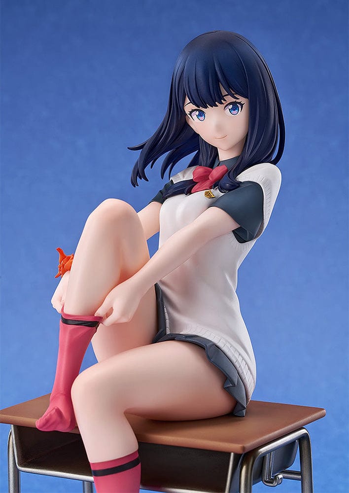 Gridman Universe Rikka Takarada (Daily School Life Ver.) 1/7 Scale Figure seated on school desk in relaxed pose with school uniform and pink socks