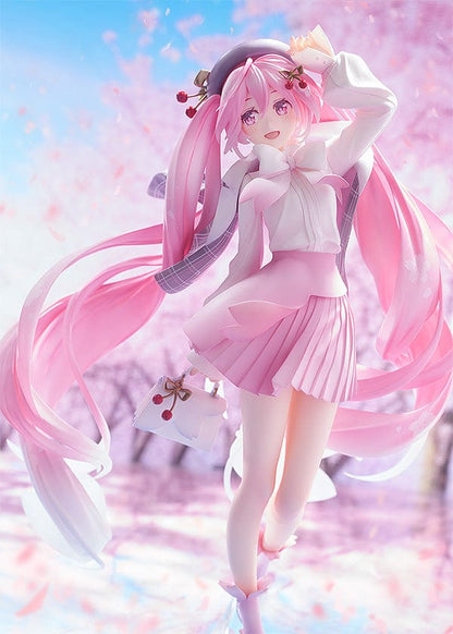 Elegant 1/6 scale figure of Sakura Miku from the Character Vocal Series, in a Hanami cherry blossom viewing outfit. She stands with one hand above her head, long pink twintails decorated with cherry blossom accents, and wears a white blouse with a pink skirt adorned with floral patterns. Miku’s joyful expression and dynamic pose evoke the celebratory spirit of cherry blossom season.