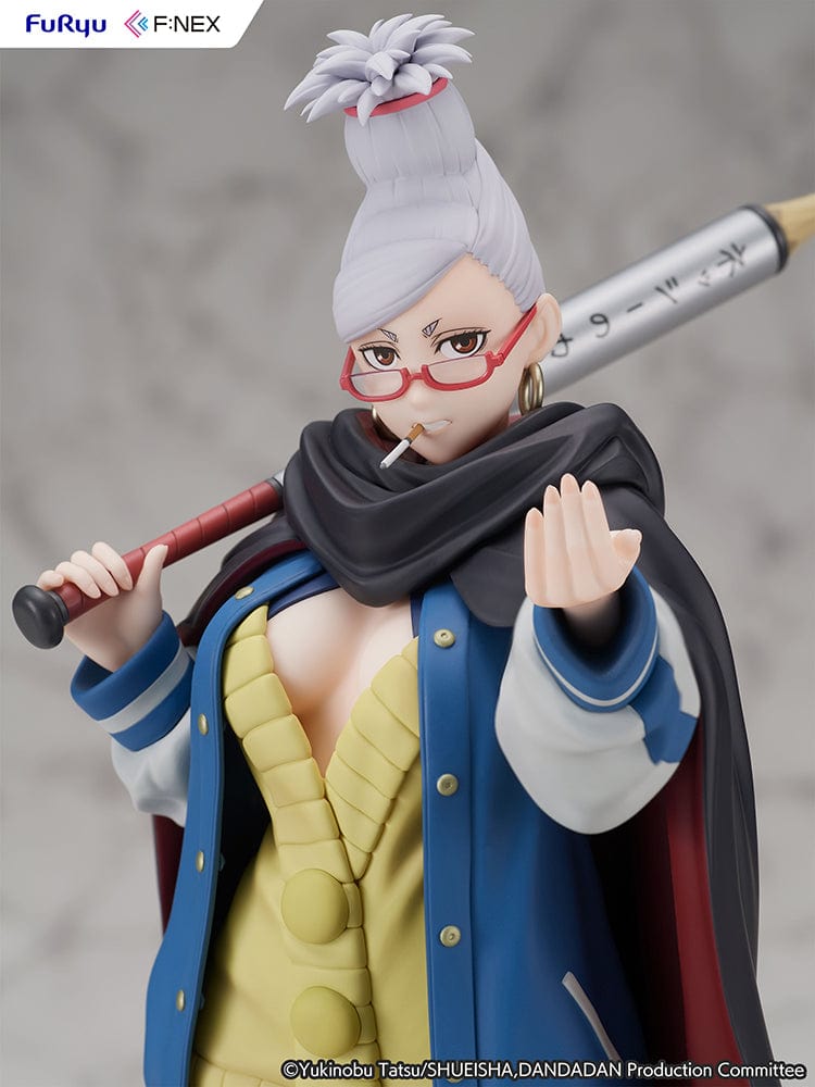 Dandadan Seiko Ayase 1/7 Scale Figure wearing a varsity jacket, yellow sweater dress, and red glasses, wielding a pencil-shaped weapon.