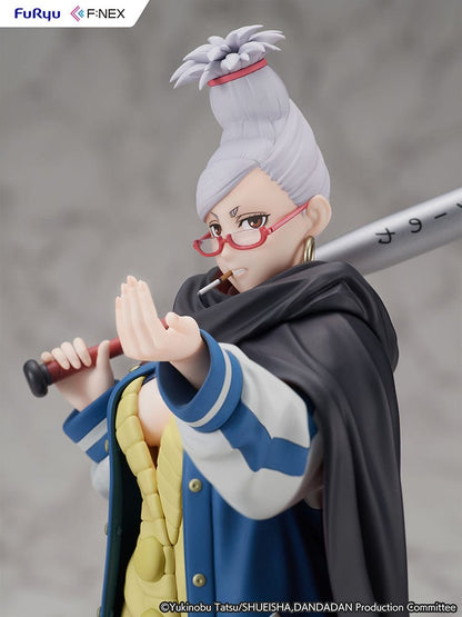 Dandadan Seiko Ayase 1/7 Scale Figure wearing a varsity jacket, yellow sweater dress, and red glasses, wielding a pencil-shaped weapon.