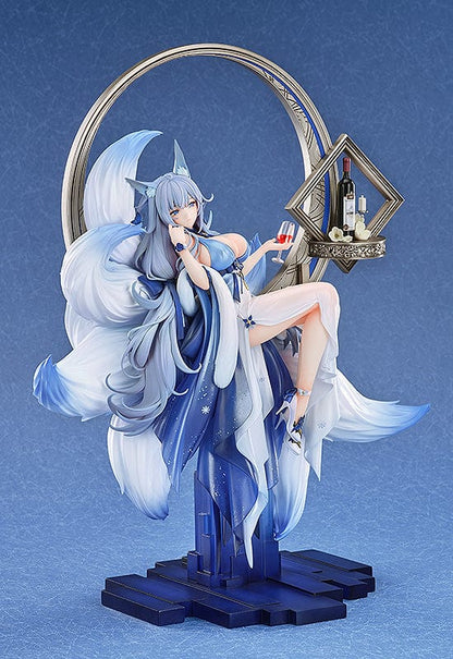 1/7 scale figure of Shinano from Azur Lane titled 'Dream of the Hazy Moon,' featuring her sitting on a crescent moon with a glass of wine, dressed in a flowing blue and white dress, with an ornate shelf containing a bottle and glasses to her side.