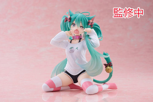 Hatsune Miku Desktop Cute Figure - Adorable and colorful figure of Hatsune Miku sitting playfully with a surprised expression, dressed in a casual leek-themed t-shirt and striped leg warmers, perfect for adding a touch of cuteness to any desk or shelf.