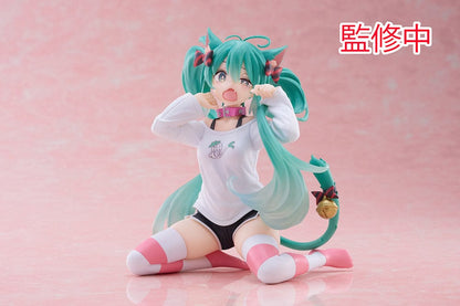 Hatsune Miku Desktop Cute Figure - Adorable and colorful figure of Hatsune Miku sitting playfully with a surprised expression, dressed in a casual leek-themed t-shirt and striped leg warmers, perfect for adding a touch of cuteness to any desk or shelf.