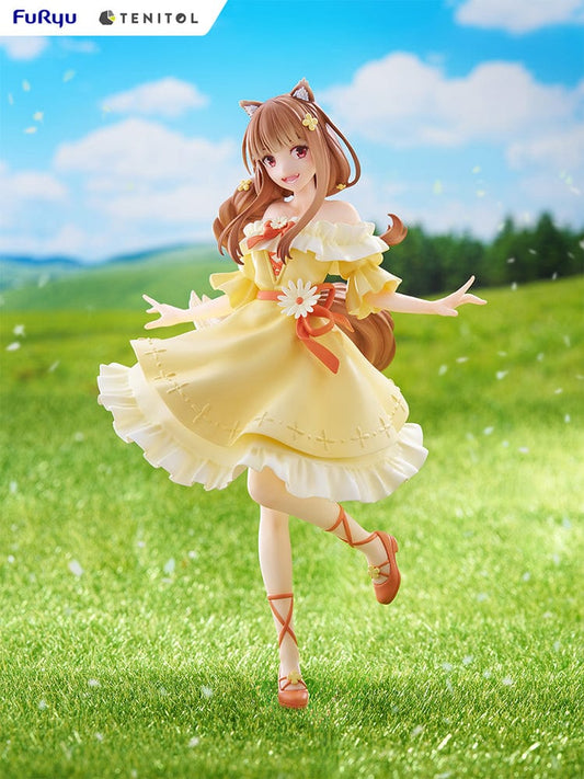 Spice and Wolf Tenitol Holo figure, featuring Holo in a joyful pose wearing a flowing yellow dress with wolf ears and tail, standing on a decorative base.