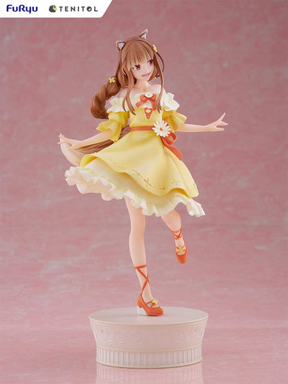 Spice and Wolf Tenitol Holo figure, featuring Holo in a joyful pose wearing a flowing yellow dress with wolf ears and tail, standing on a decorative base.