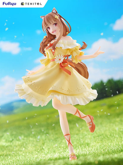 Spice and Wolf Tenitol Holo figure, featuring Holo in a joyful pose wearing a flowing yellow dress with wolf ears and tail, standing on a decorative base.