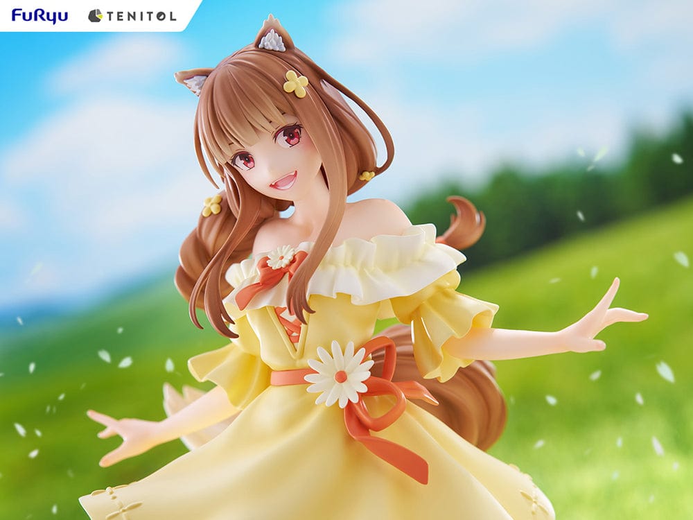 Spice and Wolf Tenitol Holo figure, featuring Holo in a joyful pose wearing a flowing yellow dress with wolf ears and tail, standing on a decorative base.