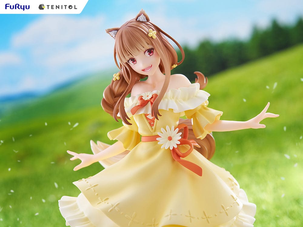 Spice and Wolf Tenitol Holo figure, featuring Holo in a joyful pose wearing a flowing yellow dress with wolf ears and tail, standing on a decorative base.