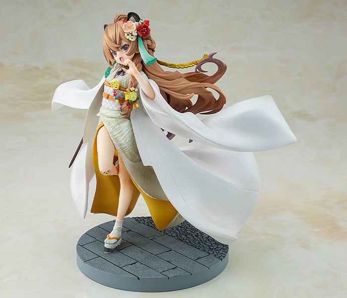 "Animated figure of Taiga Aisaka wearing a white kimono with a flowing white and yellow obi sash, accented by a tiger pattern. She has brown hair with floral decorations, steps forward on a cobblestone-pattern base, and has a spirited expression."