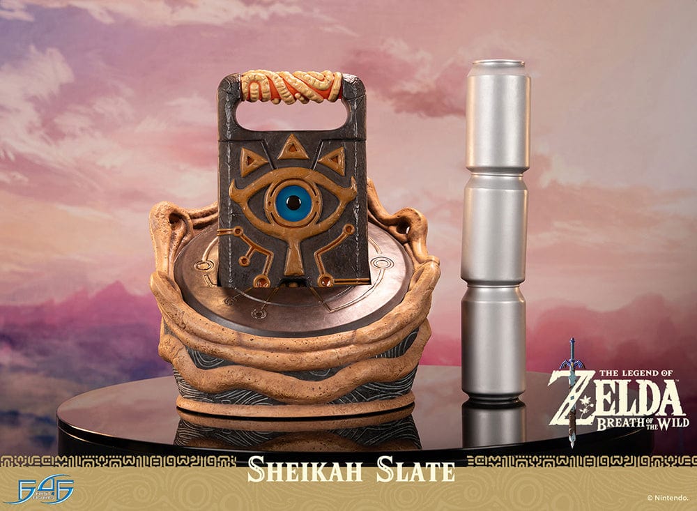 Statue of the Sheikah Slate from 'The Legend of Zelda: Breath of the Wild', with detailed carvings and symbols, against a scenic Hyrule background, part of a limited edition collectible set.