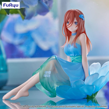 The Quintessential Quintuplets Bloo-me! Miku Nakano Figure, featuring Miku in a pastel blue floral dress, seated gracefully on a petal-like base with a serene expression and intricate detailing.