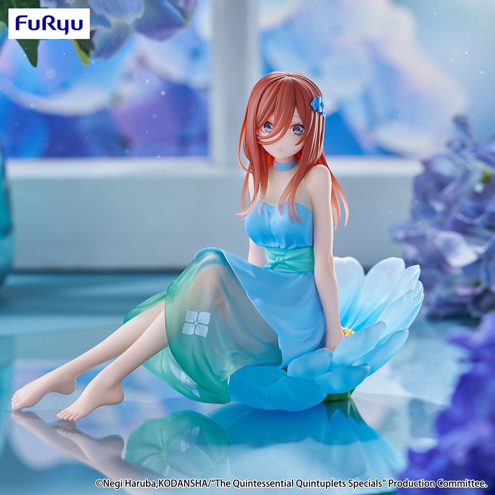 The Quintessential Quintuplets Bloo-me! Miku Nakano Figure, featuring Miku in a pastel blue floral dress, seated gracefully on a petal-like base with a serene expression and intricate detailing.