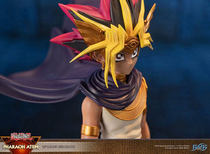 Yu-Gi-Oh! Pharaoh Atem Limited Edition Statue featuring the ancient ruler in his traditional regalia with headdress and flowing cape, perched on an Egyptian-themed pedestal, capturing his commanding presence in a finely detailed resin sculpture.