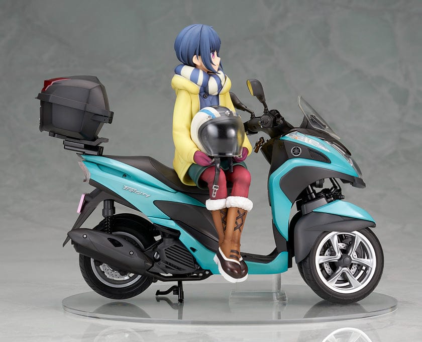 Laid-Back Camp Rin Shima 1/10 Scale Figure seated on a detailed turquoise three-wheeled scooter, wearing winter camping gear with a scarf and boots.