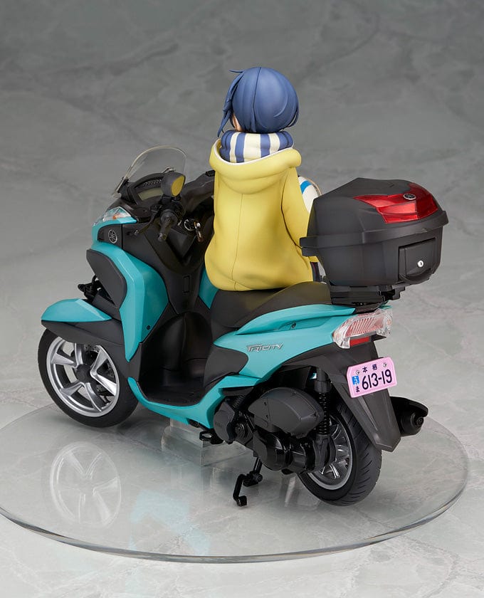 Laid-Back Camp Rin Shima 1/10 Scale Figure seated on a detailed turquoise three-wheeled scooter, wearing winter camping gear with a scarf and boots.