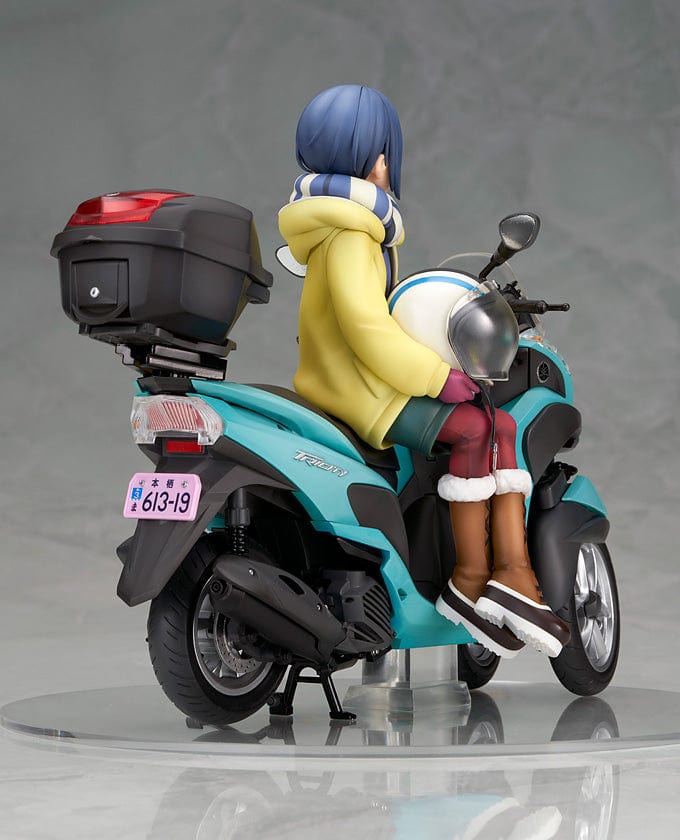 Laid-Back Camp Rin Shima 1/10 Scale Figure seated on a detailed turquoise three-wheeled scooter, wearing winter camping gear with a scarf and boots.