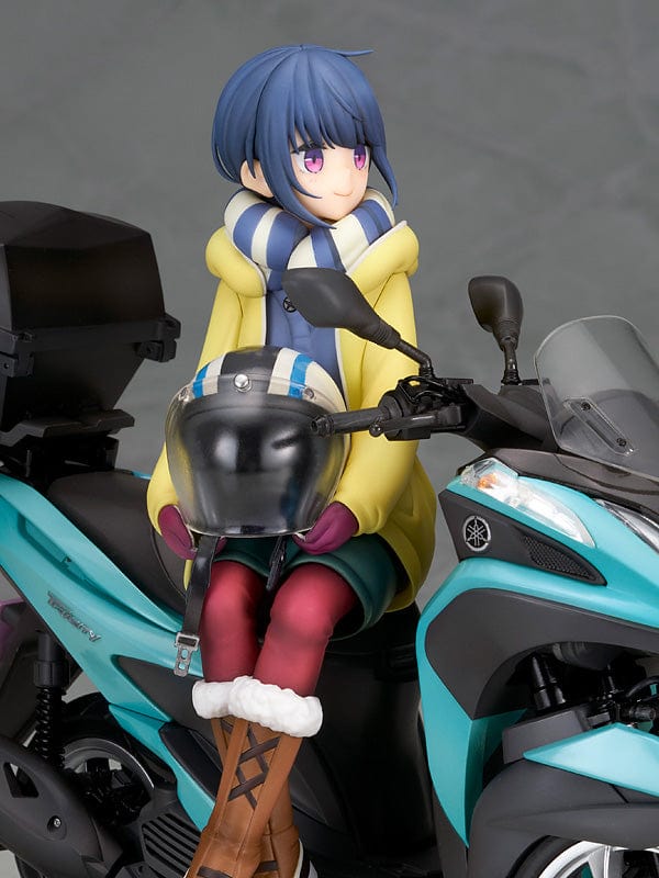 Laid-Back Camp Rin Shima 1/10 Scale Figure seated on a detailed turquoise three-wheeled scooter, wearing winter camping gear with a scarf and boots.