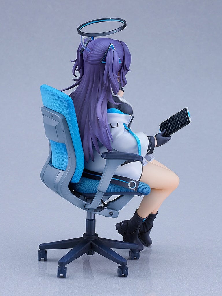 A figure of Yuuka Hayase from 'Blue Archive' in the 'Daily Life of a Treasurer Ver.,' seated in a swivel chair with a tablet in hand and a gentle smile, dressed in a school uniform with a halo above her head.